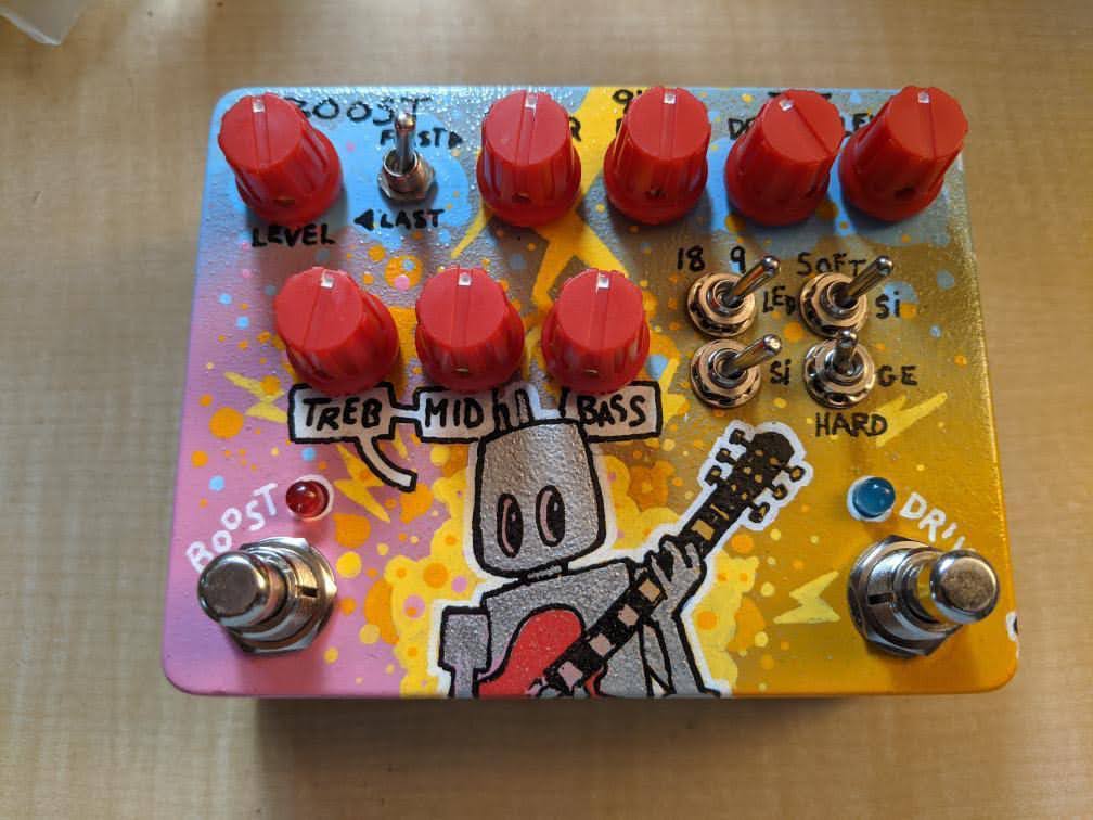 Photograph of painted guitar foot switch box with electronics and control knobs installed